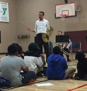 Nashville Symphony Horn Patrick Walle lays it down for students in the YMCA SMARTKids NAZA program while Principal Trombone Paul Jenkins looks on
